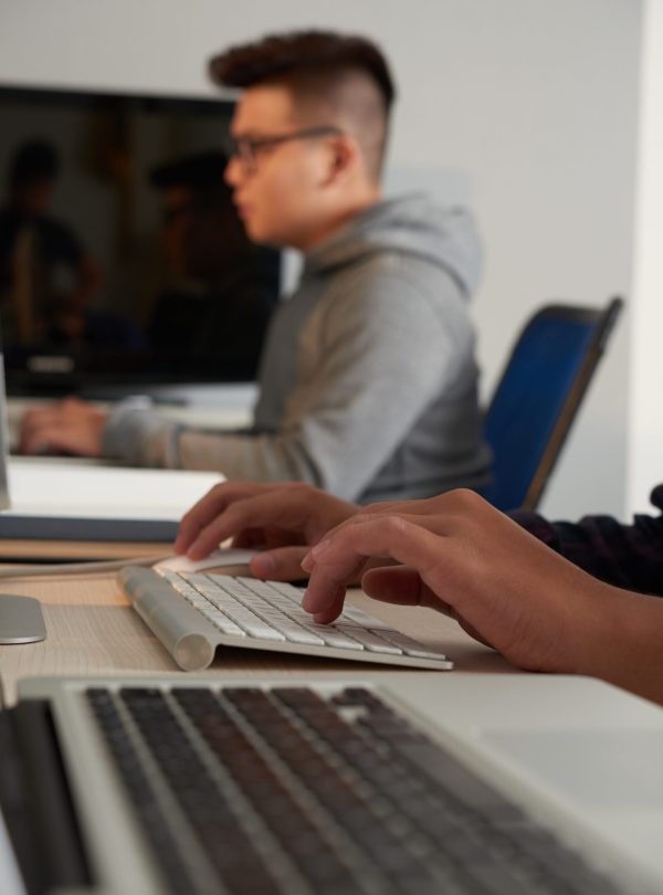 Group of university students using modern computers while having ICT class